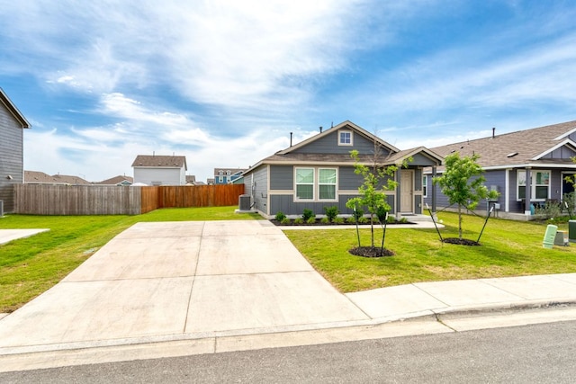 2305 Tornado Aly, Lockhart, TX 78644 - view of front of house with fence, a front lawn, and cooling unit