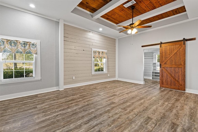 empty room with wood ceiling, a barn door, a ceiling fan, and visible vents