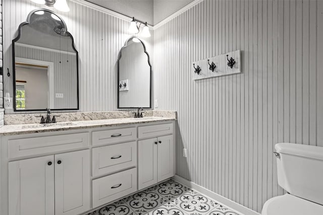 full bath with toilet, tile patterned flooring, a sink, and double vanity