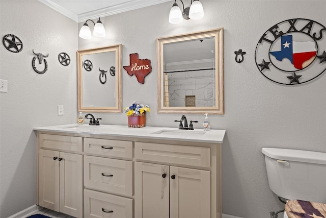 bathroom with toilet, ornamental molding, a sink, and double vanity
