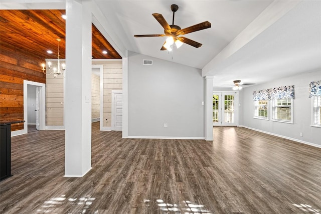 unfurnished living room with dark wood finished floors, decorative columns, visible vents, ceiling fan with notable chandelier, and lofted ceiling