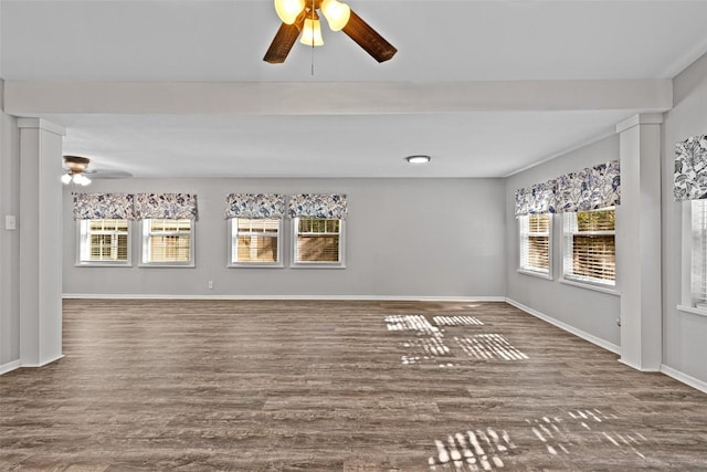 unfurnished living room featuring wood finished floors, ceiling fan, and a healthy amount of sunlight