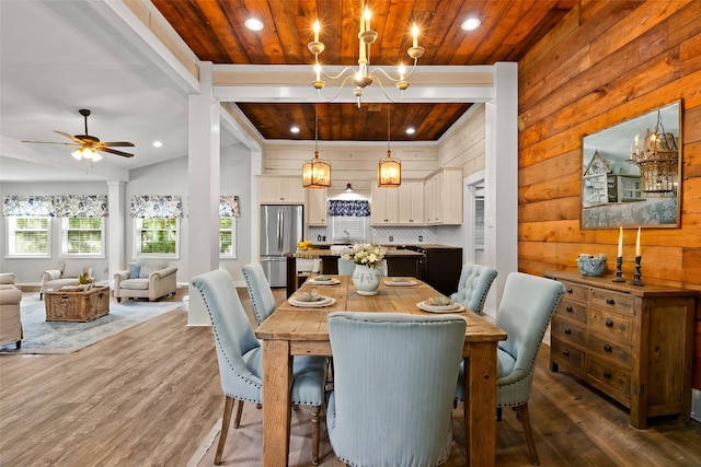 dining space featuring ceiling fan with notable chandelier, wooden ceiling, wood finished floors, and recessed lighting