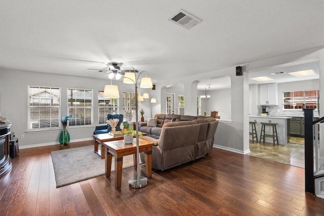 2205 Milan Dr, Cedar Park, TX 78613 - living area with dark wood-style flooring, arched walkways, ceiling fan, and a chandelier