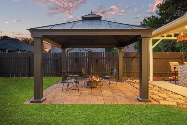 2205 Milan Dr, Cedar Park, TX 78613 - patio terrace at dusk featuring a gazebo, an outdoor fire pit, and a patio