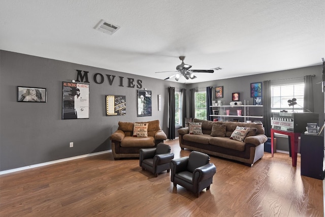 2205 Milan Dr, Cedar Park, TX 78613 - living room featuring wood finished floors, ceiling fan, and a textured ceiling