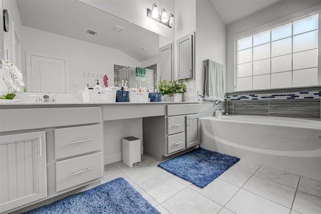 full bathroom featuring lofted ceiling, tile patterned flooring, vanity, a bath, and a shower stall