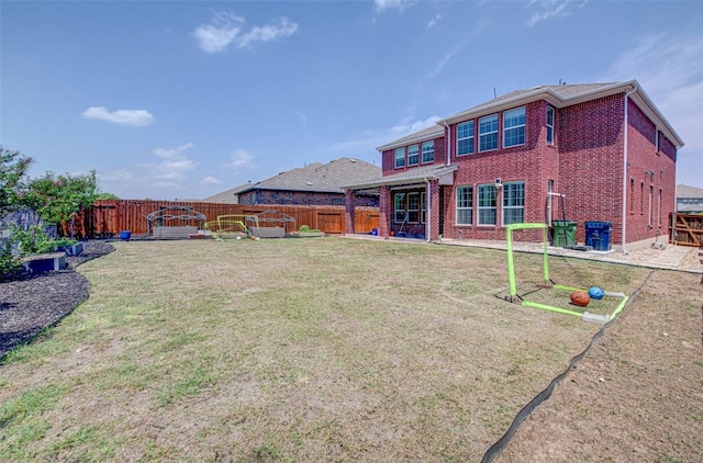 1117 Arbor Acres Loop, Leander, TX 78641 - rear view of property with brick siding and a patio area