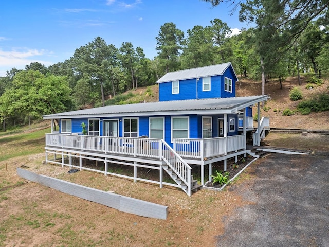 129 Valley Spur, Smithville, TX 78957 - view of front of house featuring covered porch and a metal roof