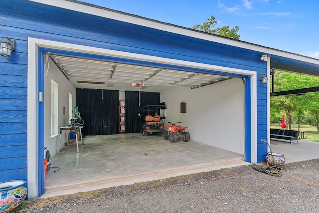 129 Valley Spur, Smithville, TX 78957 - garage featuring a garage door opener