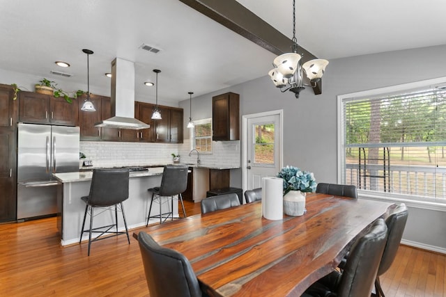 129 Valley Spur, Smithville, TX 78957 - dining area featuring healthy amount of natural light, light wood finished floors, a chandelier, and recessed lighting
