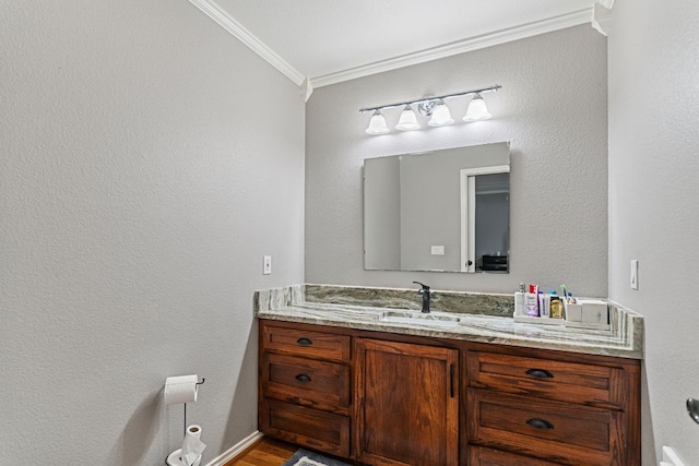 129 Valley Spur, Smithville, TX 78957 - bathroom with ornamental molding, vanity, and wood finished floors