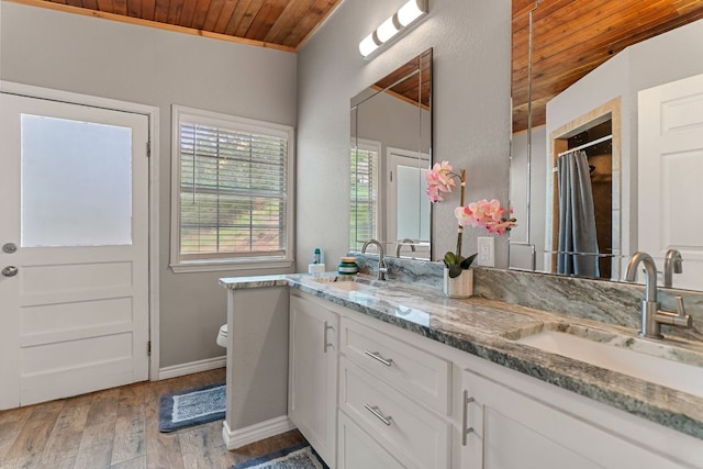 129 Valley Spur, Smithville, TX 78957 - full bath featuring wood finished floors, wooden ceiling, and a sink