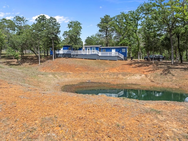 129 Valley Spur, Smithville, TX 78957 - exterior space with a deck with water view