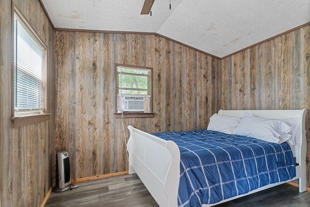 129 Valley Spur, Smithville, TX 78957 - bedroom with lofted ceiling, wooden walls, wood finished floors, and cooling unit