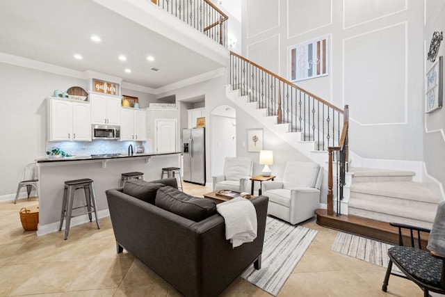 218 Sunrise Ridge Loop, Lakeway, TX 78738 - living area featuring stairs, ornamental molding, a high ceiling, recessed lighting, and light tile patterned floors