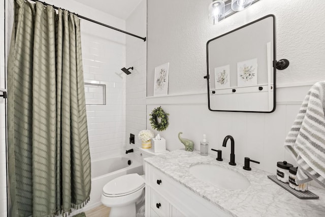 218 Sunrise Ridge Loop, Lakeway, TX 78738 - full bathroom featuring vanity, shower / bath combo, a textured wall, and wainscoting