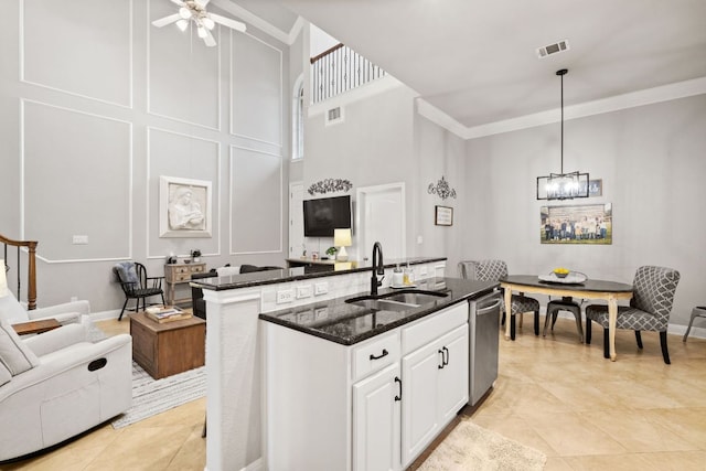 218 Sunrise Ridge Loop, Lakeway, TX 78738 - kitchen featuring stainless steel dishwasher, crown molding, open floor plan, dark stone countertops, and ceiling fan