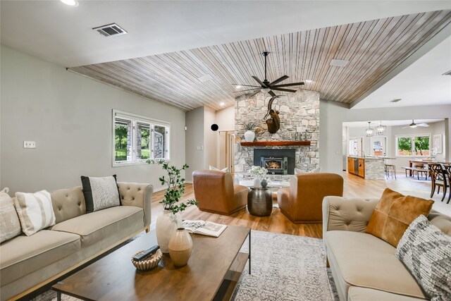 2305 Manana St, Austin, TX 78730 - living room with a ceiling fan, healthy amount of natural light, light wood-style floors, a stone fireplace, and vaulted ceiling