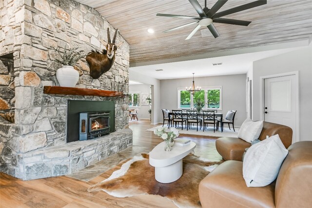 2305 Manana St, Austin, TX 78730 - living room featuring wood finished floors, ceiling fan, a fireplace, wooden ceiling, and a chandelier