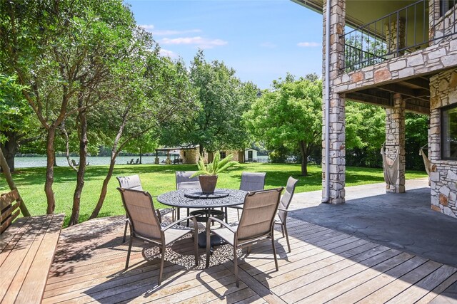 2305 Manana St, Austin, TX 78730 - wooden terrace with a lawn, outdoor dining space, a water view, an outbuilding, and a patio area