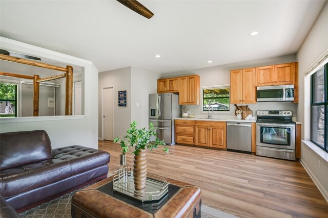 2305 Manana St, Austin, TX 78730 - kitchen featuring appliances with stainless steel finishes, a sink, light wood-type flooring, light countertops, and recessed lighting