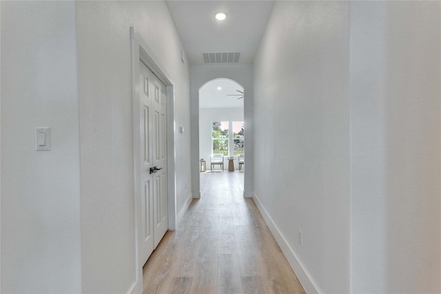353 Nene Ln, Bastrop, TX 78602 - corridor with light wood-style flooring, baseboards, arched walkways, and recessed lighting