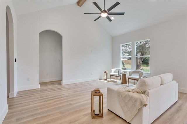 353 Nene Ln, Bastrop, TX 78602 - living area featuring arched walkways, high vaulted ceiling, a ceiling fan, beam ceiling, and light wood finished floors