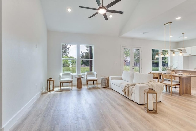 living room featuring recessed lighting, a ceiling fan, vaulted ceiling, and light wood-style flooring