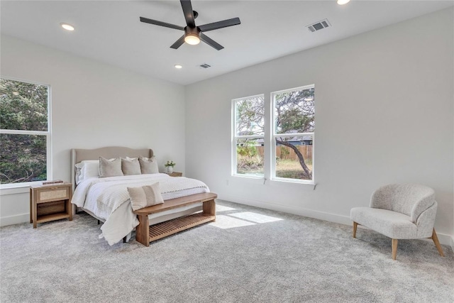 carpeted bedroom with baseboards, visible vents, recessed lighting, and multiple windows