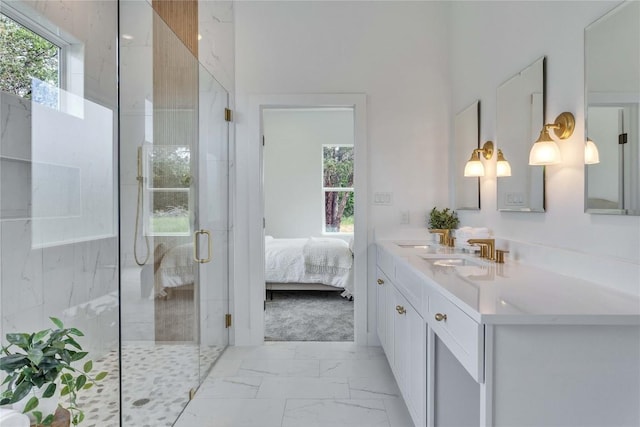 ensuite bathroom with vanity, marble finish floor, a shower stall, and a healthy amount of sunlight