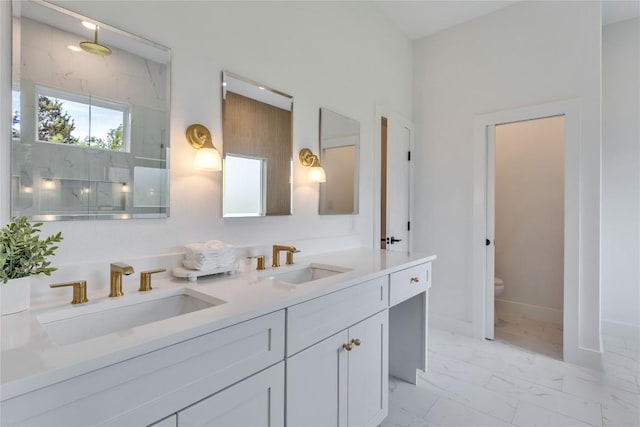 353 Nene Ln, Bastrop, TX 78602 - bathroom featuring double vanity, marble finish flooring, toilet, and a marble finish shower