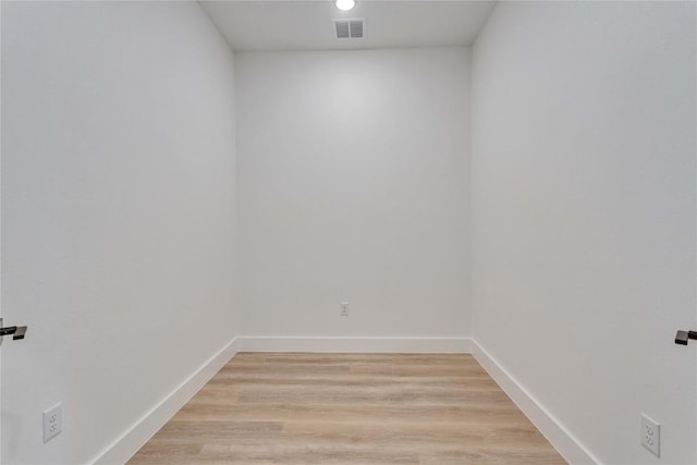 empty room with baseboards, light wood-style flooring, and visible vents