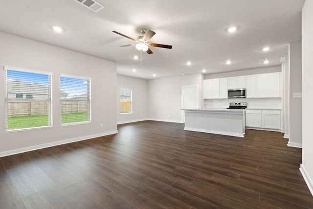 208 Lazy Lizzy Rd, Jarrell, TX 76537 - unfurnished living room with a ceiling fan, dark wood-style flooring, and recessed lighting
