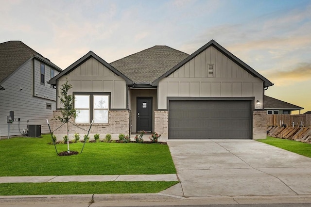 208 Lazy Lizzy Rd, Jarrell, TX 76537 - view of front of property featuring board and batten siding, a garage, driveway, a shingled roof, and brick siding