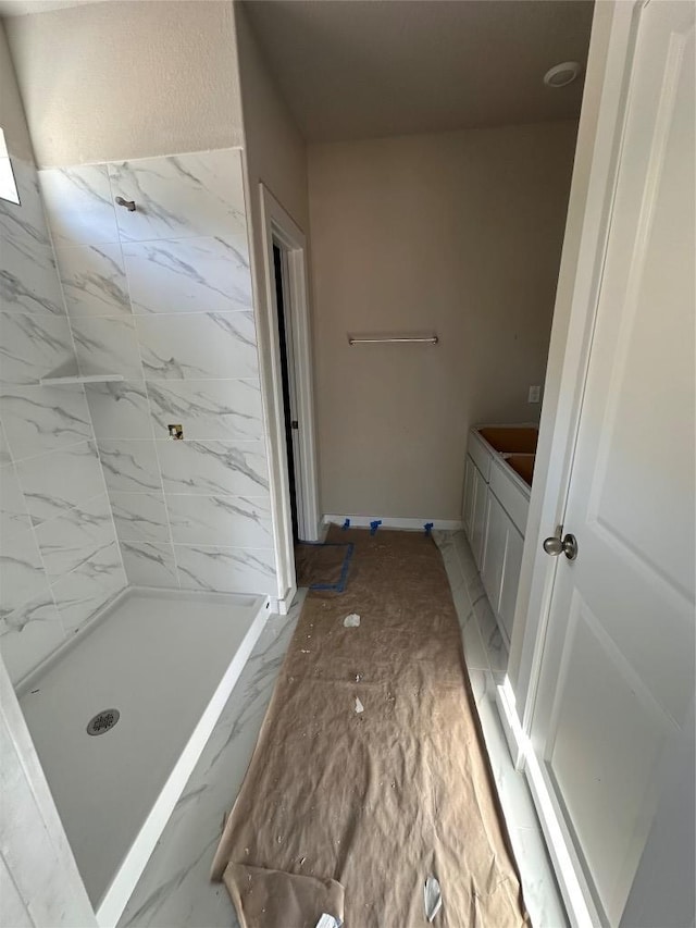 full bathroom with a shower stall and marble finish floor