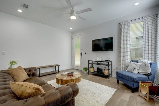 living room with light wood finished floors, a ceiling fan, visible vents, and recessed lighting