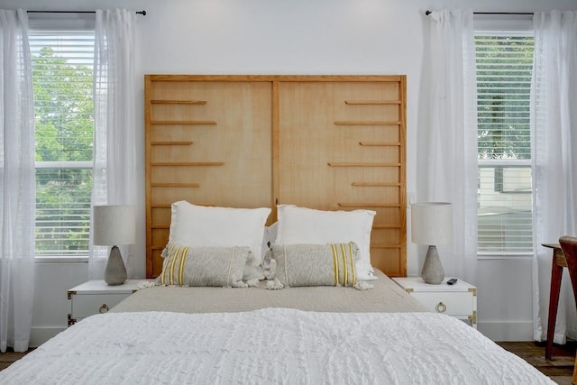 bedroom featuring baseboards and multiple windows