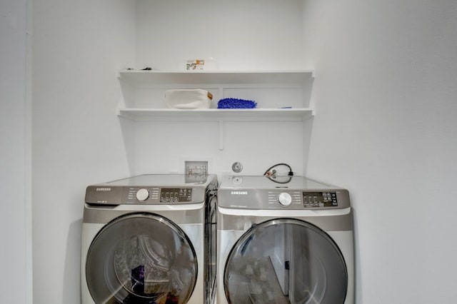 washroom featuring washing machine and clothes dryer and laundry area