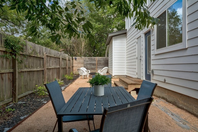 view of patio with outdoor dining space and a fenced backyard