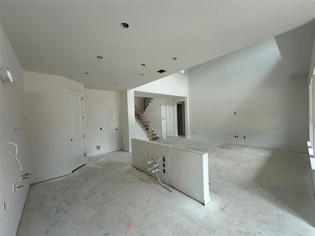 22120 Cross Timber Bnd, Lago Vista, TX 78645 - unfurnished living room featuring concrete floors and stairway