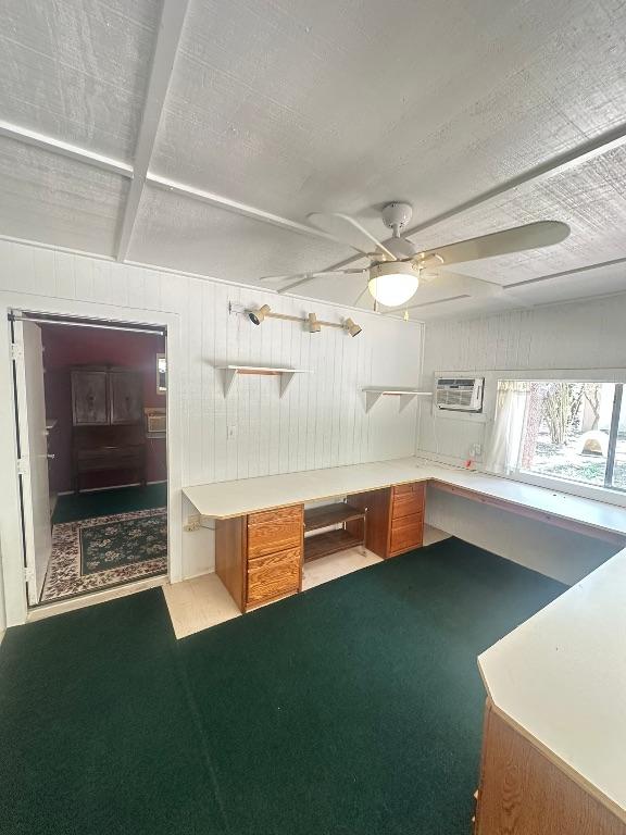 interior space featuring a wall mounted air conditioner, open shelves, brown cabinets, wooden walls, and ceiling fan