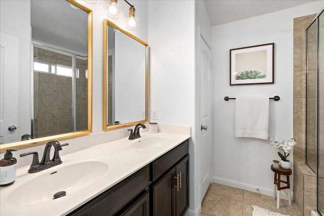 bathroom with a sink, double vanity, and tiled shower