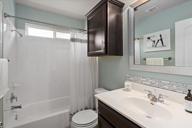 bathroom featuring toilet, visible vents, shower / tub combo, decorative backsplash, and vanity