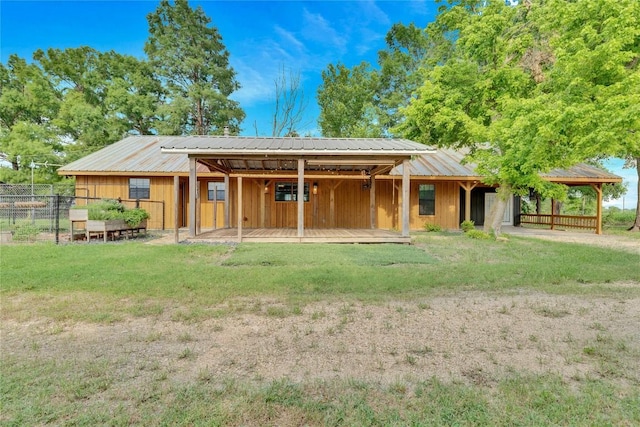 rear view of property featuring metal roof
