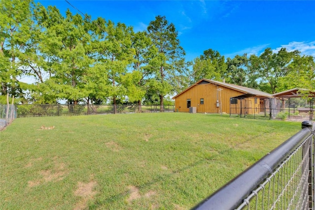 view of yard with an outbuilding and central AC