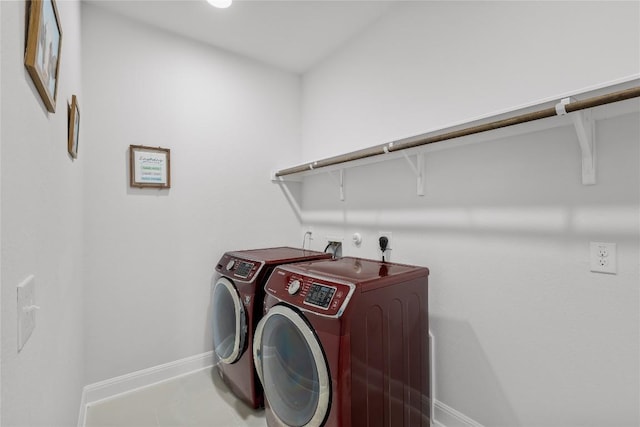 laundry room with washer and clothes dryer, baseboards, and laundry area
