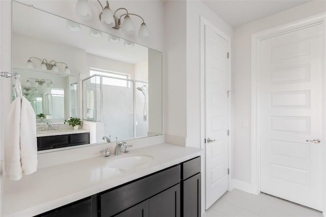 full bath featuring tile patterned floors, vanity, and a shower stall