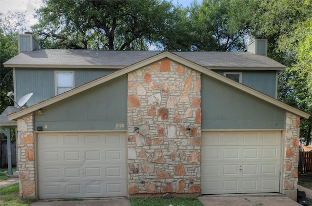 garage featuring concrete driveway