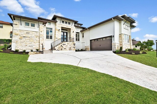905 Crestone Stream Dr, Austin, TX 78738 - prairie-style house with stone siding, a front lawn, french doors, driveway, and an attached garage